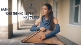 :         / Russian girl plays the harp in the street