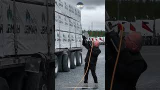 Pneumatic strap launcher tool helps truck drivers throw cargo tie-downs perfectly