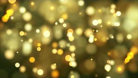 Golden Bokeh Lights Fading And Moving Slowly On Warm Background