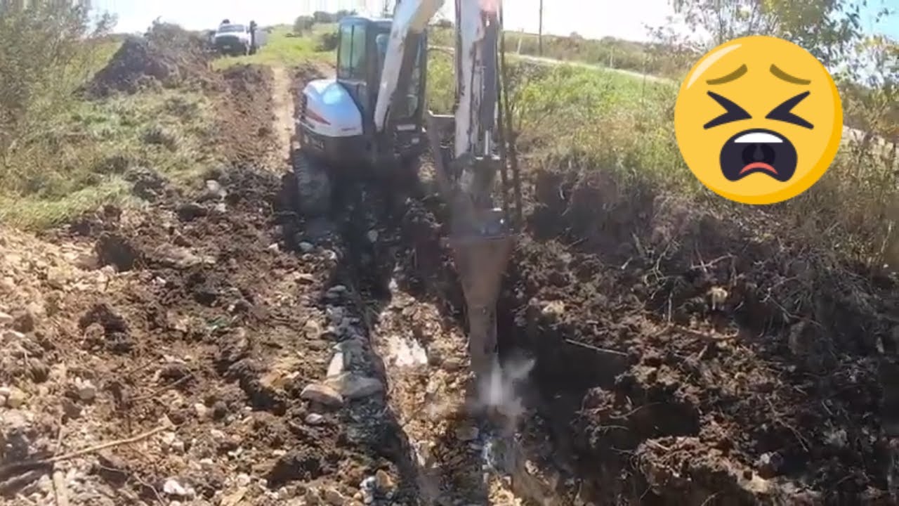 E50 Bobcat Installing A Water Line Sleeve Through A Creek YouTube