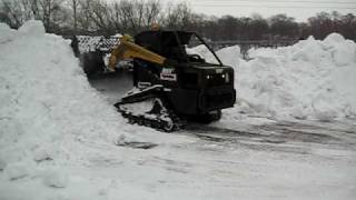 ASV PT100 with 101" snow bucket piling snow