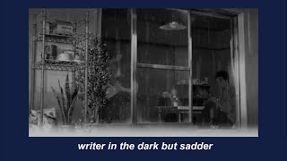 writer in the dark on a rainy, autumn night