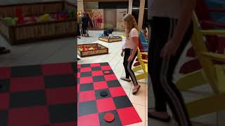 Kids playing checkers at the mall