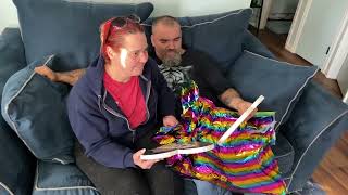 Denise and John Keith opening their Rainbow Pet Portraits of Reno and Bella. Painted by Katie!