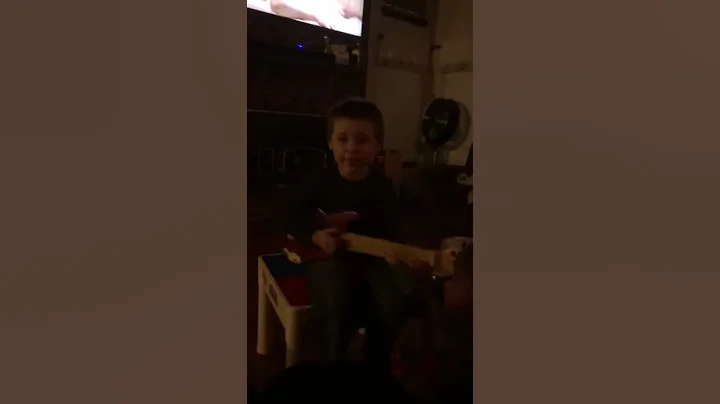 My son singing and playing the guitar