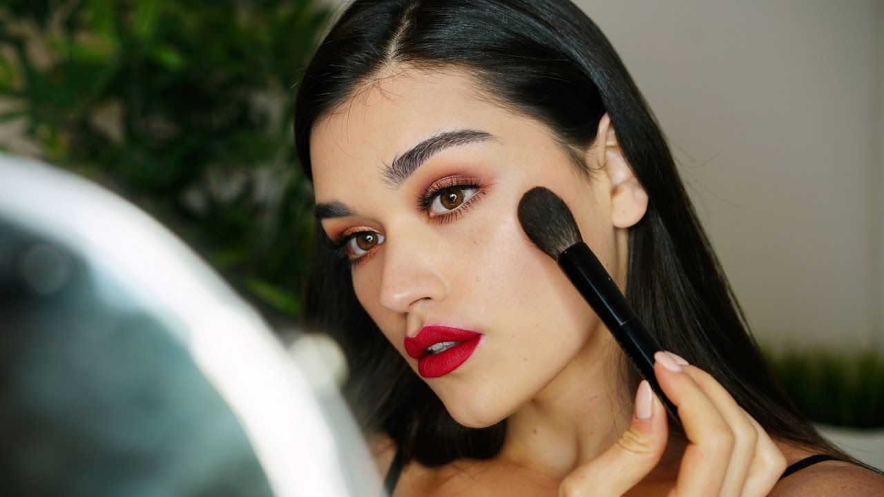 Premium Photo | A woman with a red eye makeup and a dark red dress