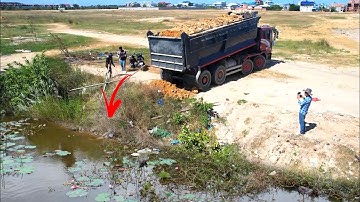 First start opening new Work by heavy dump truck 25T unloading soil with bulldozer D41P working push