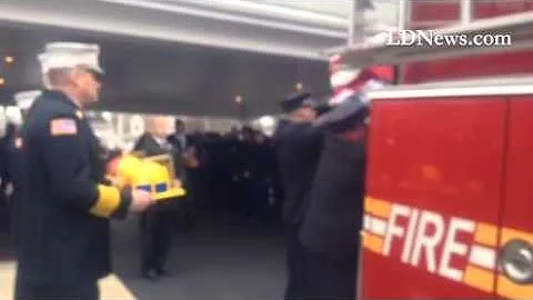 Firefighters carry Dylan Holt's casket to an Elizabethtown fire truck for procession to cemetery Sat