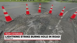 Lightning leaves smoking hole in pavement along Hatfield street
