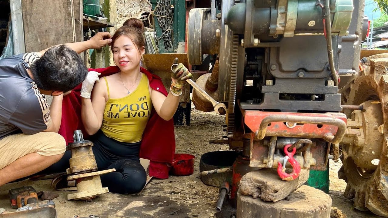 The talented girl repairs and replaces the cylinders in tractor engines.