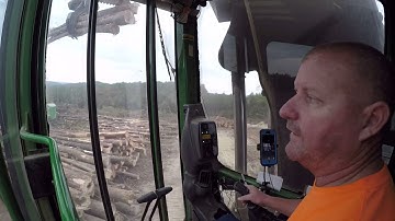 John Deere loading Peterbilt log trucks