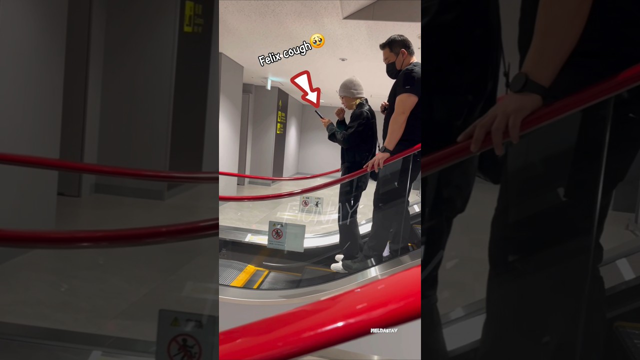 Felix and Bangchan on the airport escalator 