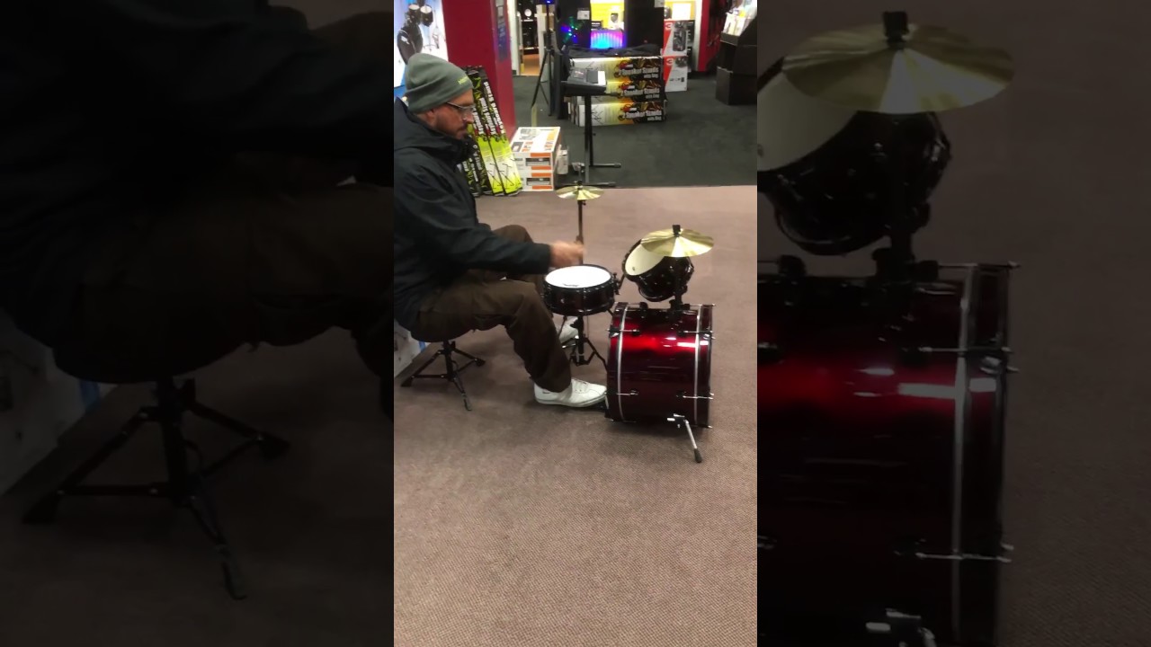 Hernan Burset playing a mini drum set