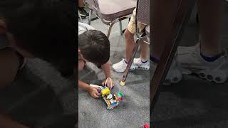 Wyatt and Ryan demonstrating their bus robot that stops at the stop sign!