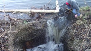 Clearing Branches From a Lake Drain After a Storm