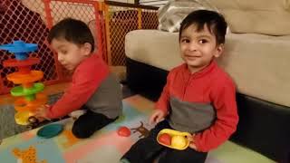 Adorable twin babies' pretend play