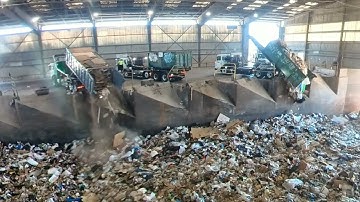 Garbage trucks dumping at transfer station
