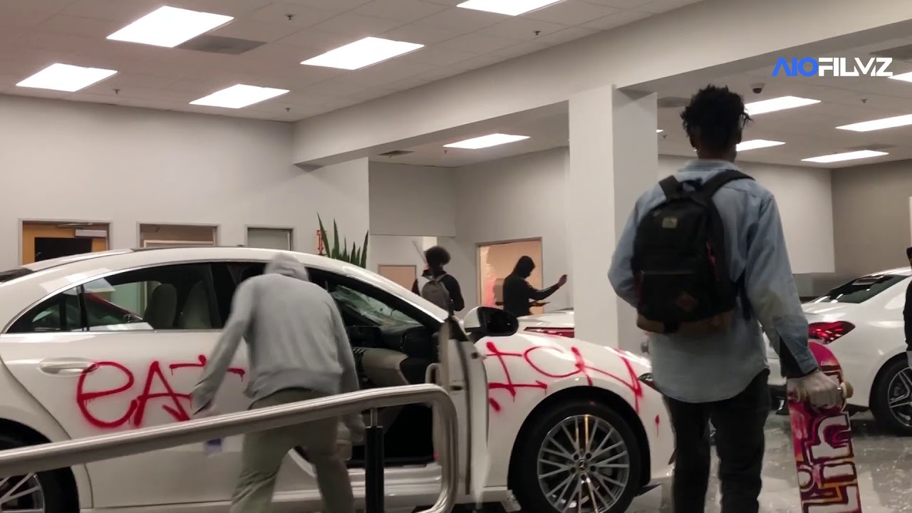 Rioters torch cars in a Mercedes-Benz dealership during protests ...