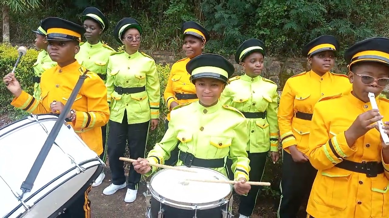 STUDENTS PRACTICING TO PLAY TRUMPETS.