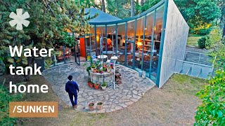 Drained water tank becomes curved, earthship-like sunken home