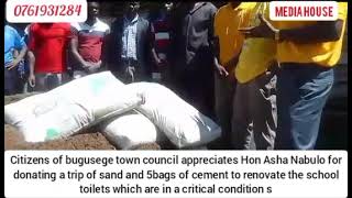 HON ASHA NABULO DONATES 5BAGS OF CEMENT AND ONE TRACK OF SAND TO RENOVATE A TOILET IN A SCHOOL