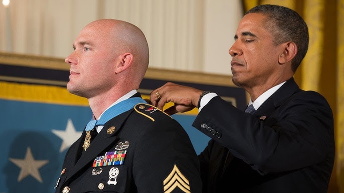 Friends of Army Sgt. 1st Class Leroy Arthur Petry inspect the Medal of  Honor he received at the White House.