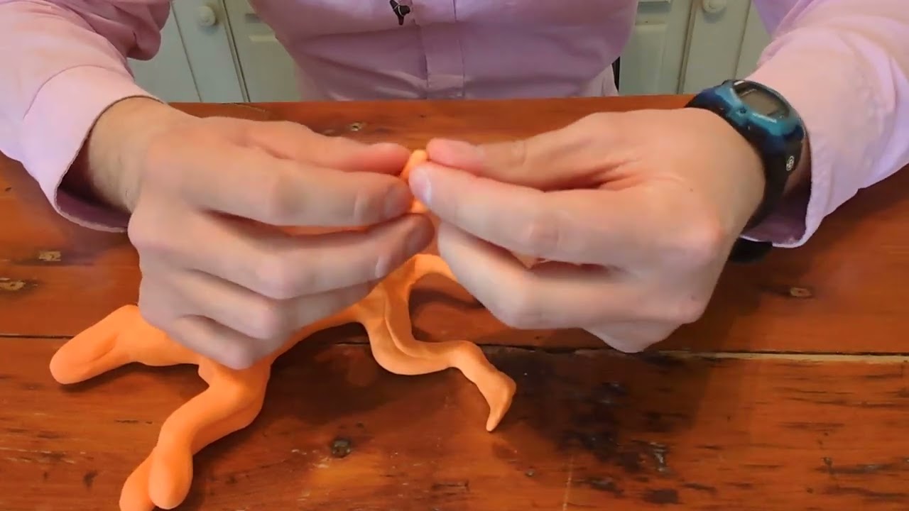Making a statue sculpture out of orange colored clay 13