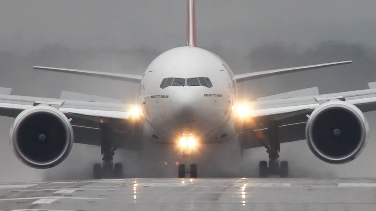 Wet runway! Emirates Boeing 777300 blowing up the water. YouTube