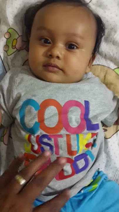 New Born kid trying to laugh.Look at the message on his t-shirt