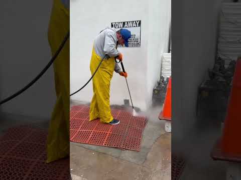 Commercial Cleaning of San Diego technician hot-water cleaning a greasy commercial kitchen floor mat