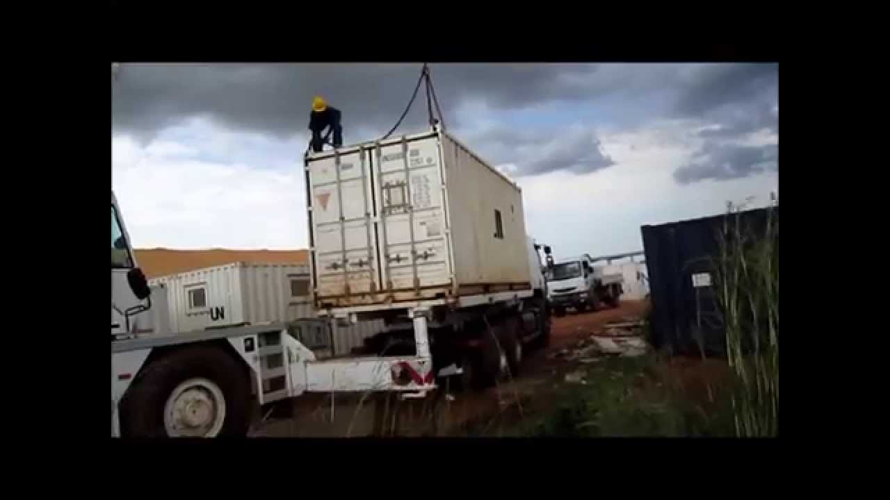 craneofaringioma Loading a Intermodal Sea Container onto a Flat bed truck using a Mobile Crane