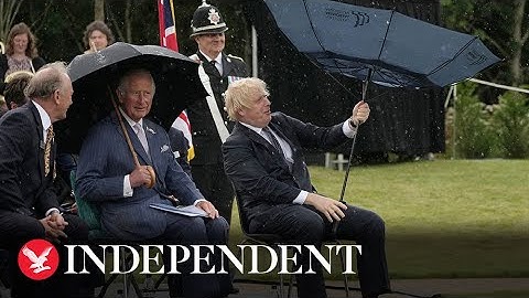 Boris Johnson struggles with umbrella at police memorial unveiling