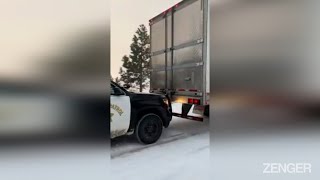 Cop Patrol Car Gives Snow Stranded Truck A Push