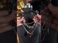 Red leather, layered chains, heart lock center