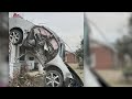 Car lands on house after hitting utility pole