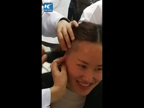 Female medics cut hair short before aiding coronavirus fight