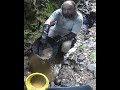 Panning gold next to a waterfall
