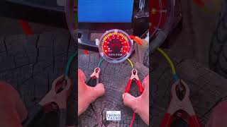 The device features a circular LED display with a percentage scale