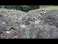 Reshaping a drainage ditch to achieve fall