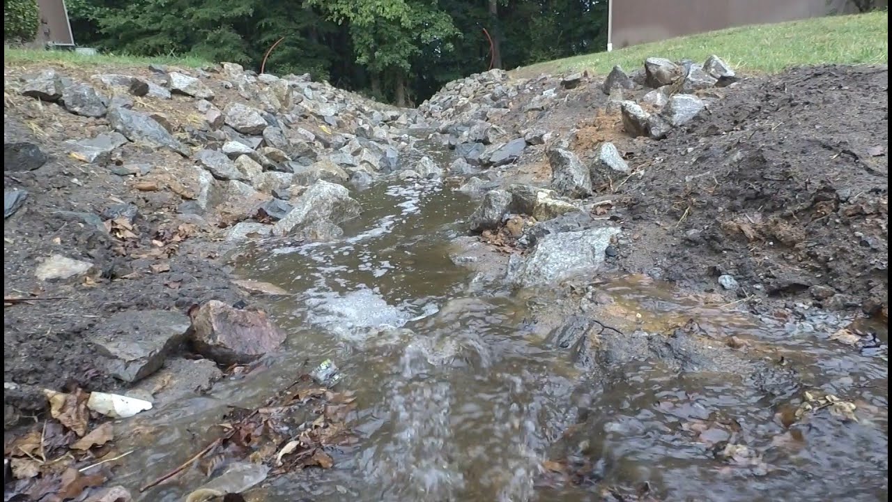 Reshaping a drainage ditch to achieve fall
