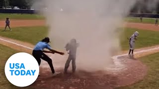 Quick-thinking umpire rescues kid caught in dust devil | USA TODAY