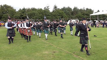 Final parade by massed Pipe Bands at the 2019 Stonehaven Highland Games in Aberdeenshire Scotland