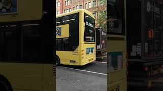Bee Network buses in  a dull Manchester city centre (2026)