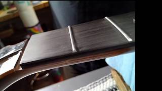 Fret end grooming with diamond fret file.