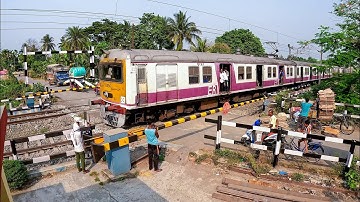 Drone View From Rail Gate High Speedy EMU Local Train Moving out Furiously Through Rail Gate