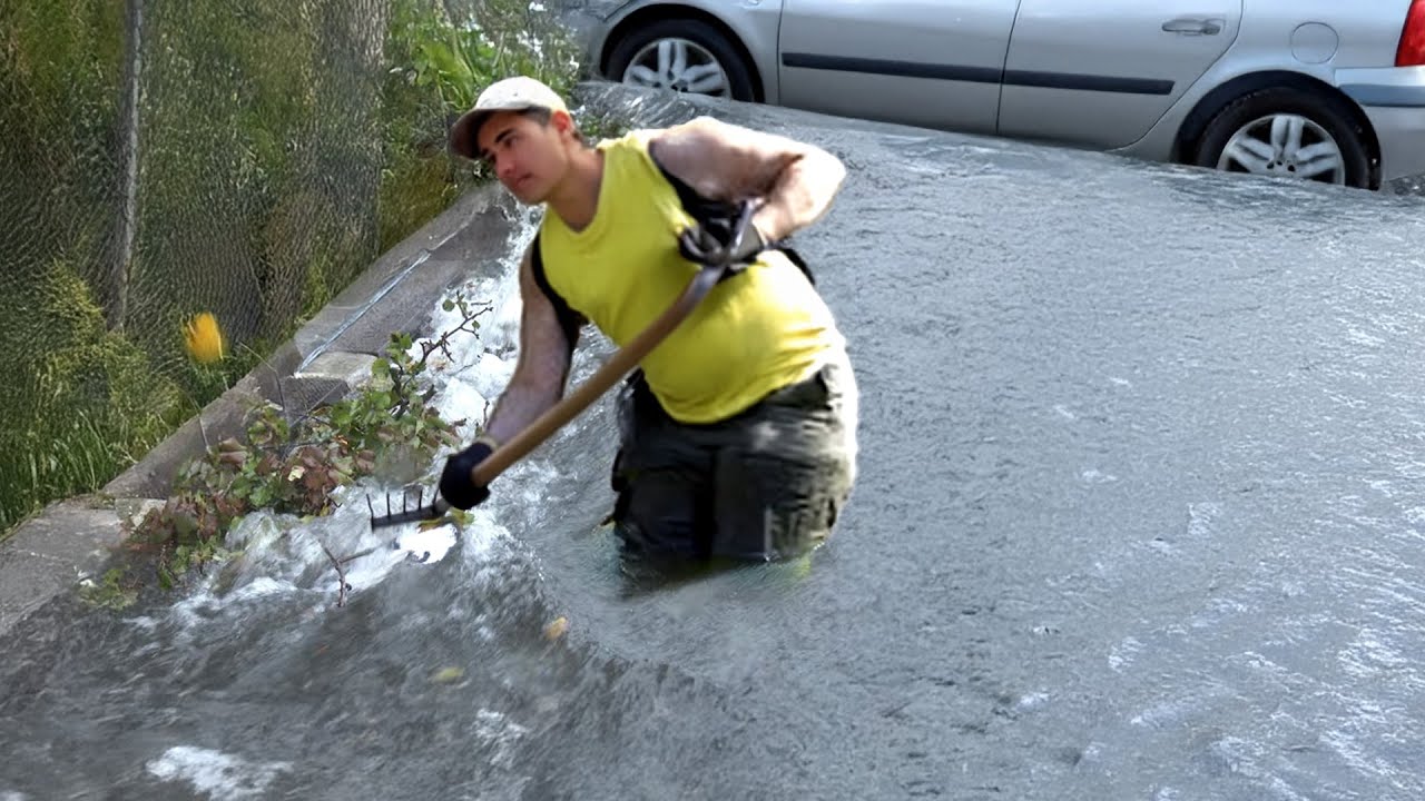 Draining the Storm Unclogging a Street Flood Drain - YouTube