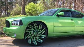 2010 Dodge Charger sitting on 26" Black&Green Azara 502 wheels wrapped in 275/25-26 lexani tires