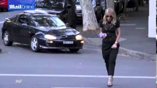 Lara Bingle bares her black bra in a sheer lace top as