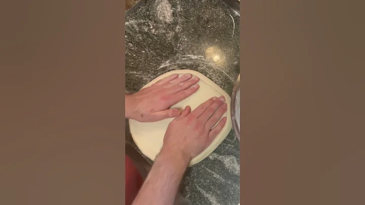 Stretching a perfectly round pizza dough!
