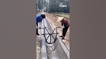 Smoothing concrete in a ditch: people smoothing concrete in a ditch
